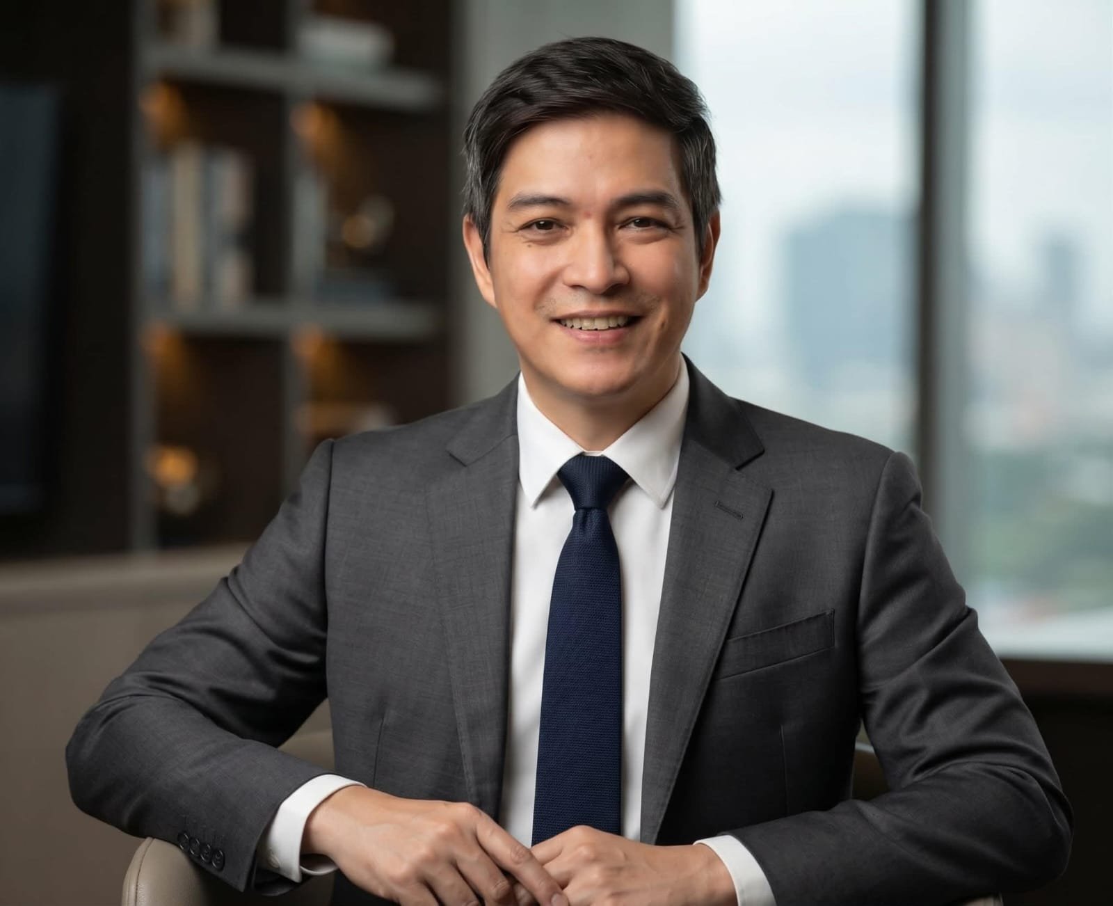 Jessie Castro, GHL professional based in the Philippines, wearing a charcoal business suit